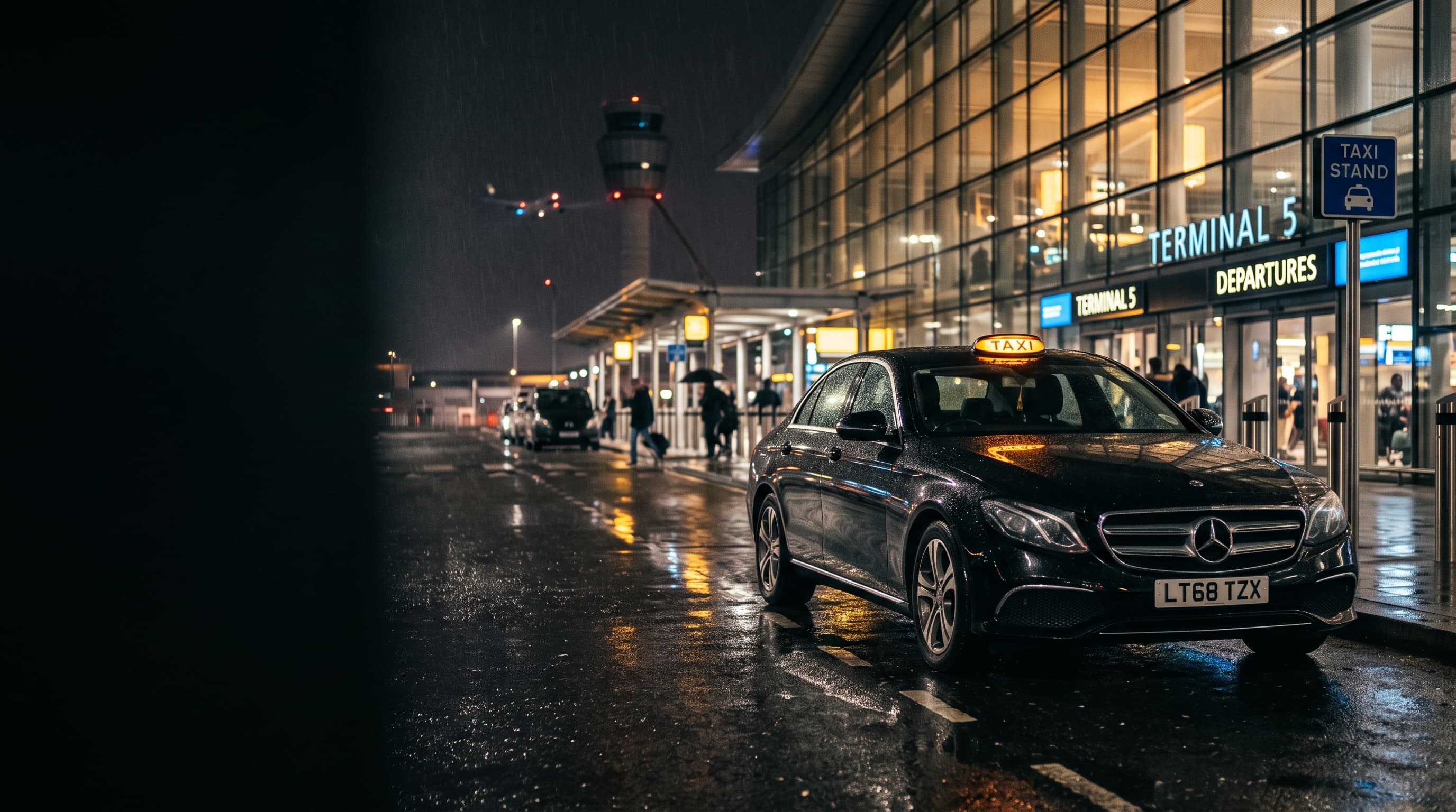 Schwarzes Mercedes-Taxi mit gelbem TAXI-Dachschild vor einem beleuchteten Flughafen-Terminal bei Nacht auf nassem Asphalt